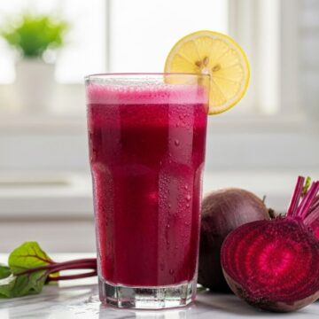 Refreshing glass of chukandar juice with lemon wedge