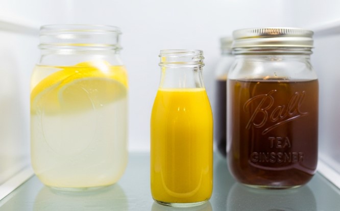turmeric shot liquid stored in fridge beside other wellness drinks