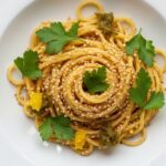 preserved lemon hummus pasta served in bowl with herbs