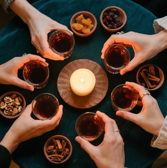 friends toasting with homemade winter herb cordial