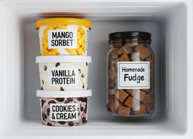 Frozen Ninja Creami pints labeled mango, vanilla, cookies & cream