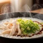 steaming bowl of rice porridge with toppings